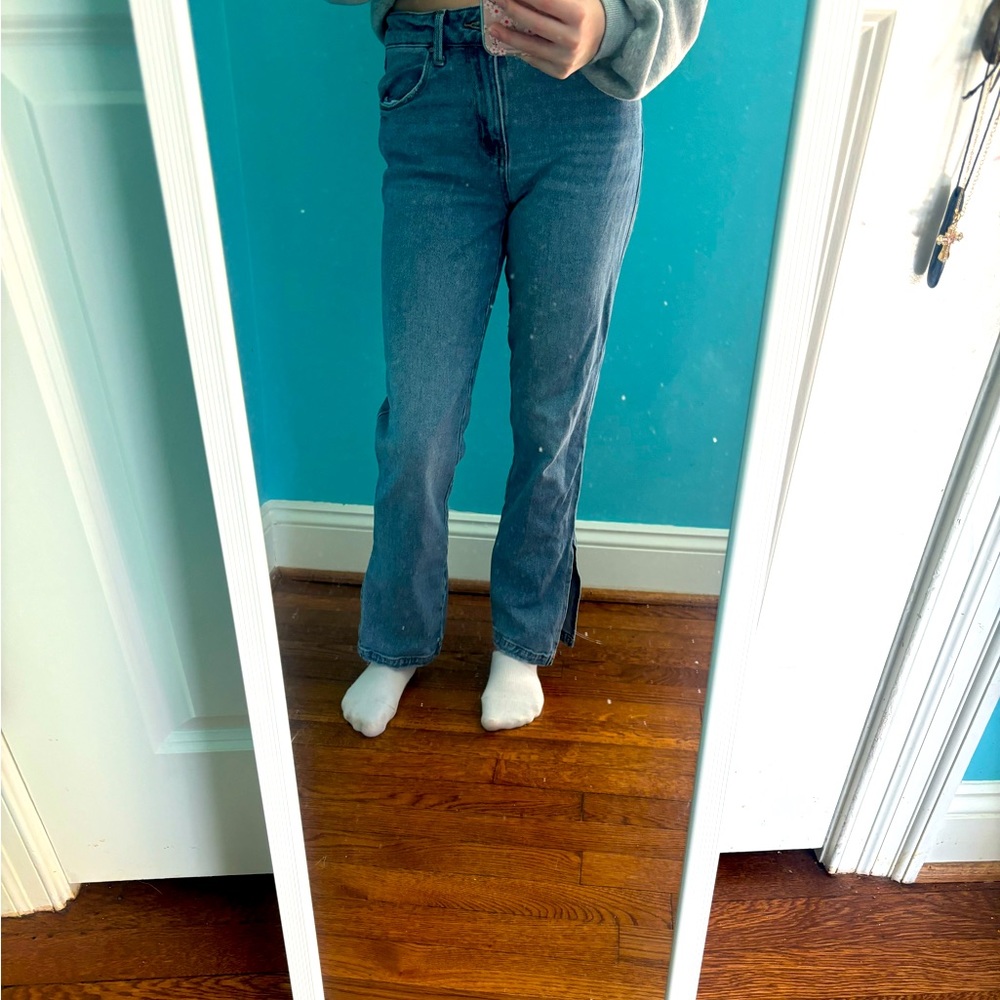 Straight jeans with sewed tear at ankles